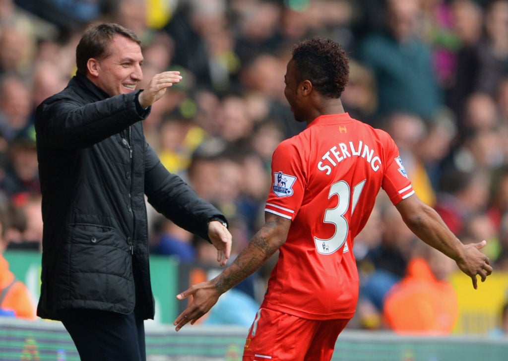Raheem Sterling of Liverpool celebrates scoring the opening goal with Manager Brendan Rodgers of Liverpool during the Barclays Premier League match between Norwich City and Liverpool at Carrow Road