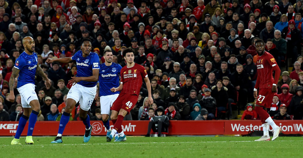 Curtis Jones watches on as he scores the winner against Everton