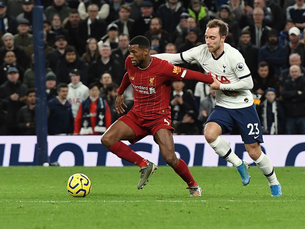 Gini Wijnaldum shields the ball from Christian Eriksen.