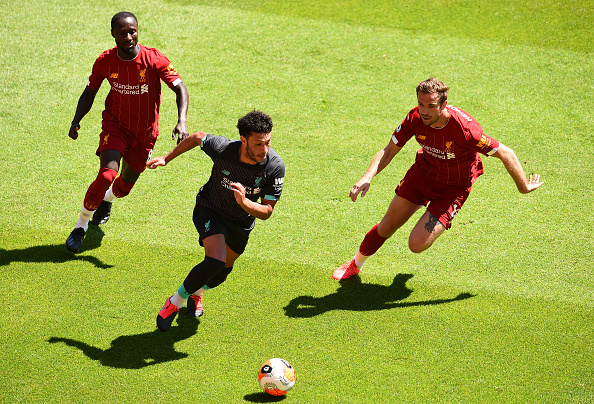 Naby Keita and Jordan Henderson track Alex Oxlade-Chamberlain.