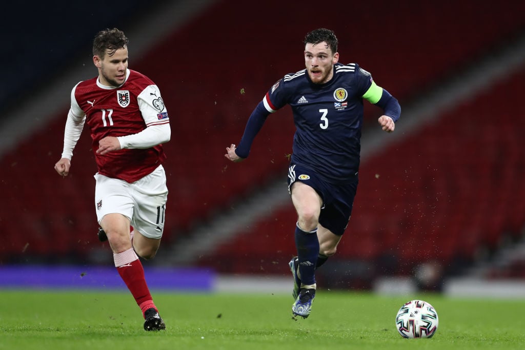 Andy Robertson of Scotland runs with the ball whilst under pressure from Louis Schaub of Austria during the FIFA World Cup 2022 Qatar qualifying match between Scotland and Austria on March 25, 2021