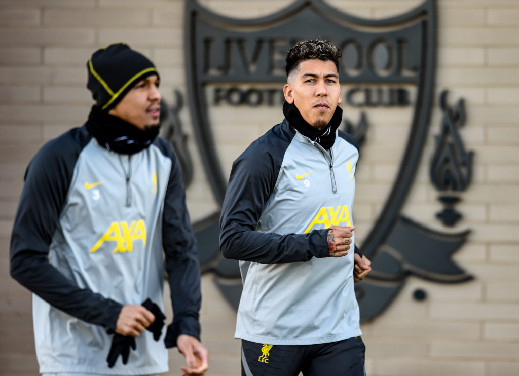 Roberto Firmino and Fabinho walk out for a Liverpool training session at the AXA Training Centre