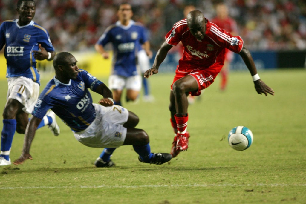 Liverpool's Momo Sissoko (red) vies with Portsmouth's Sol Campbell (blue) during final Barclays Asia Trophy game at Hong Kong Stadium. 27 JULY 2007