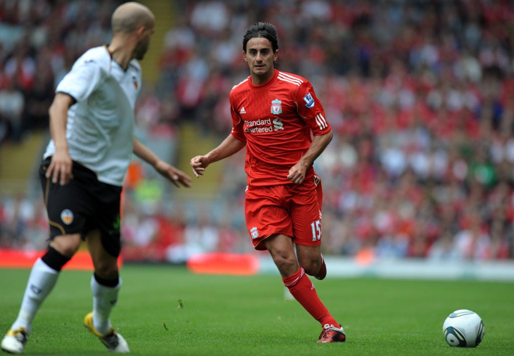 Liverpool's Alberto Aquilani (R) runs wi