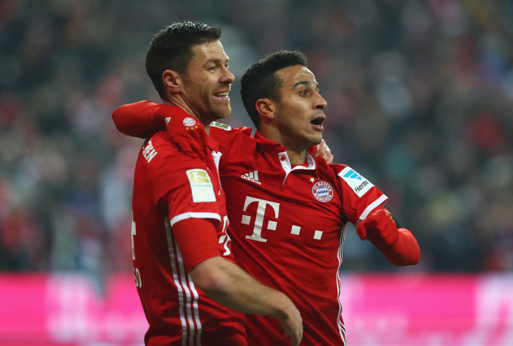 Xabi Alonso celebrates with Thiago Alcantara after scoring for Bayern Munich in the Bundesliga against RB Leipzig.