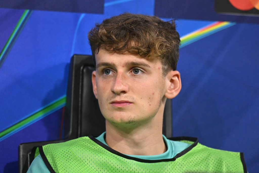 Tyler Morton watches on from the bench during Liverpool's UEFA Champions League match against AC Milan at San Siro.