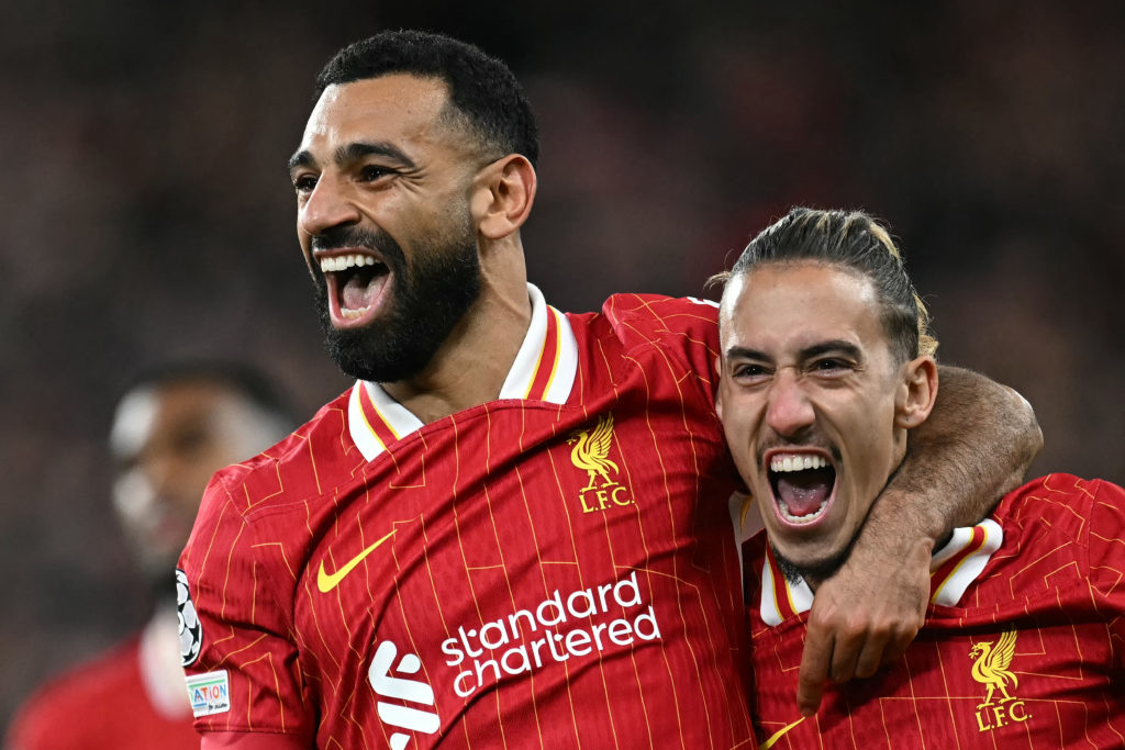 Liverpool's Egyptian striker #11 Mohamed Salah celebrates scoring the team's second goal with Liverpool's Greek defender #21 Kostas Tsimikas during the UEFA Champions League league stage football match between Liverpool and Bologna at Anfield