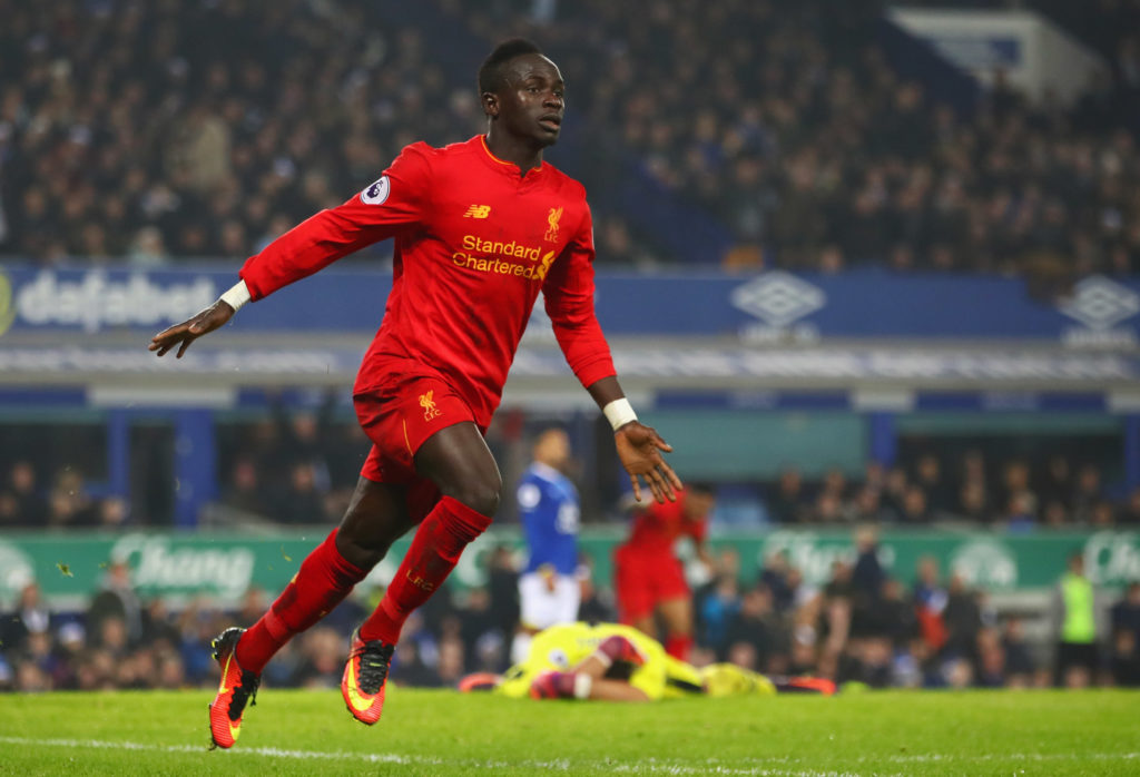 Sadio Mane of Liverpool celebrates as he scores their first goal during the Premier League match between Everton and Liverpool at Goodison Park