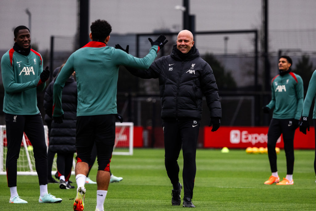 Arne Slot and Luis Diaz laugh during a Liverpool training session