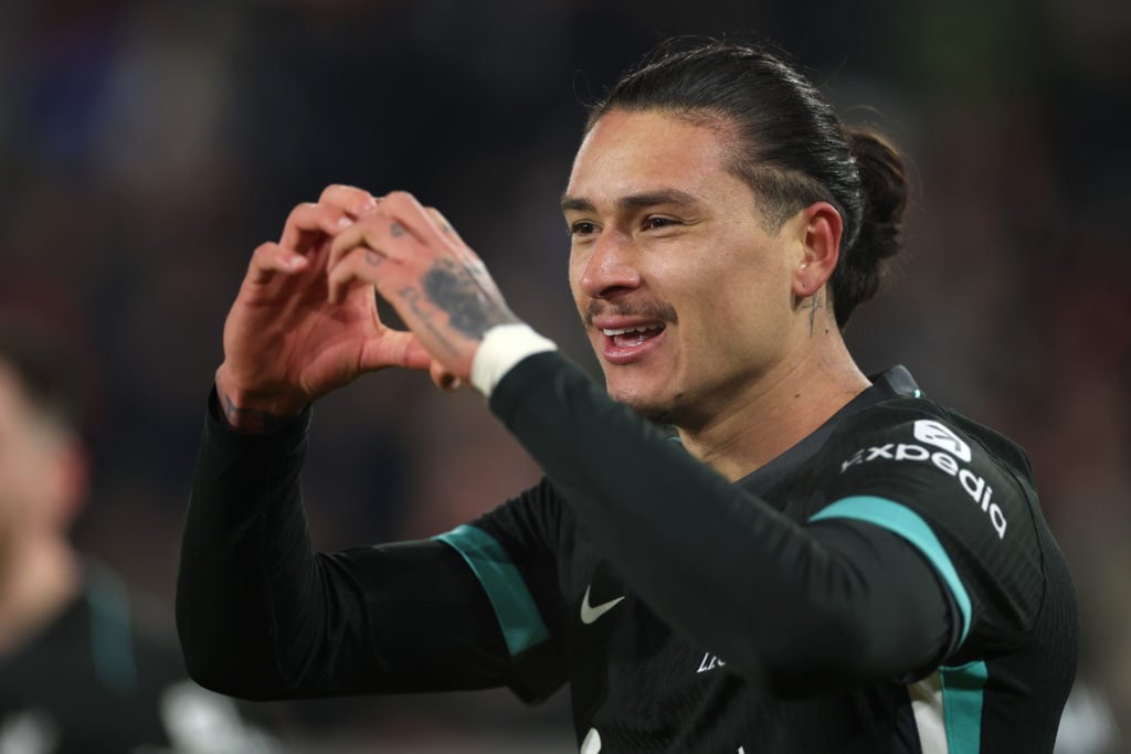 Darwin Nunez celebrating scoring for Liverpool by forming a heart with his hands.