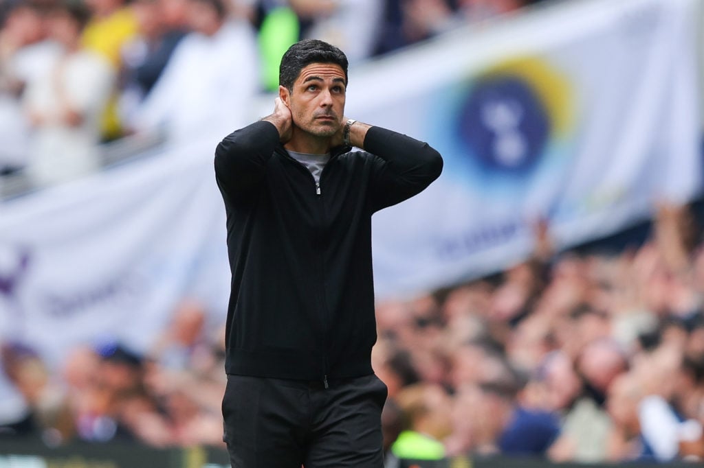 Mikel Arteta with his head in his hands during Arsenal's game against Tottenham.