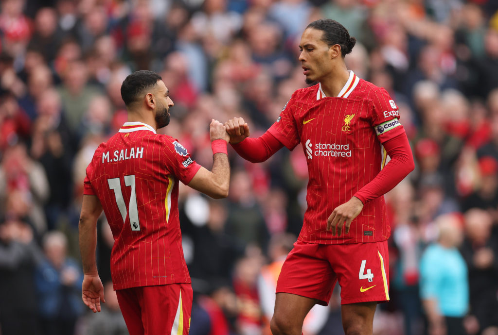Mohamed Salah and Virgil van Dijk fist-bumping during a Premier League game for Liverpool.