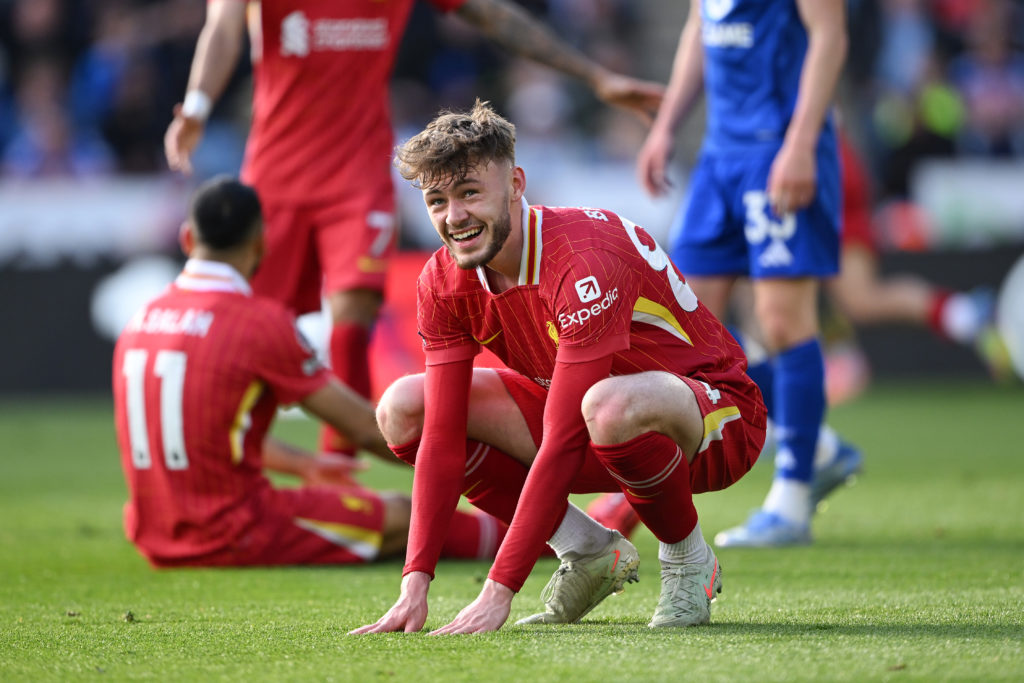 Conor Bradley grimaces as he bends down to touch the pitch during Liverpool's Premier League match against Leicester City.