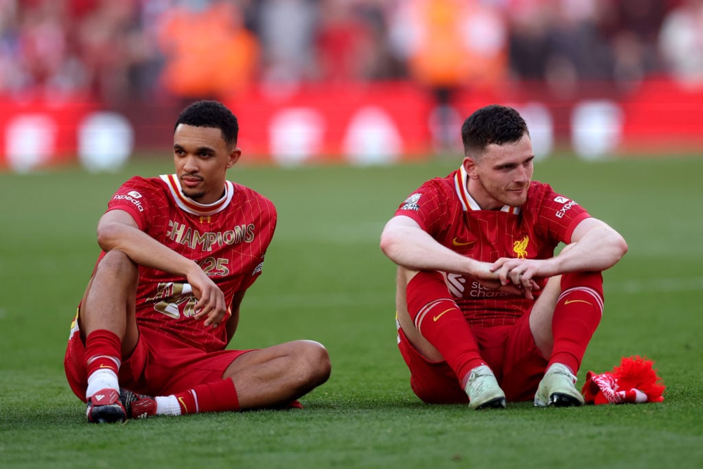 Trent Alexander-Arnold and Andrew Robertson of Liverpool look on, as they celebrate the teams victory and confirmation of winning the Premier League title after the Premier League match between Liverpool FC and Tottenham Hotspur FC at Anfield
