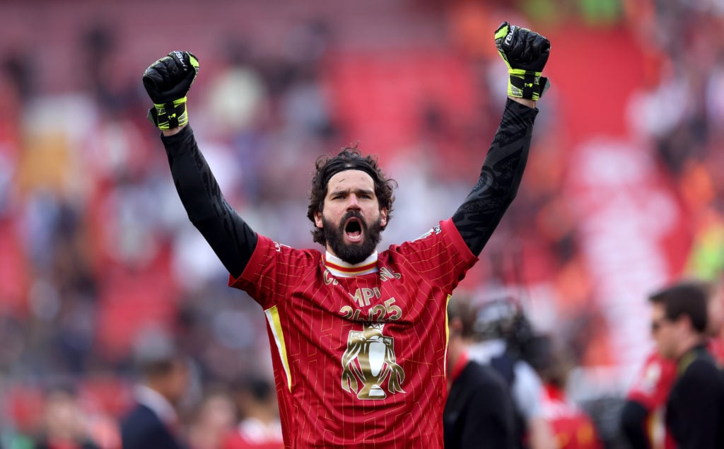 Alisson celebrating Liverpool's Premier League title win.
