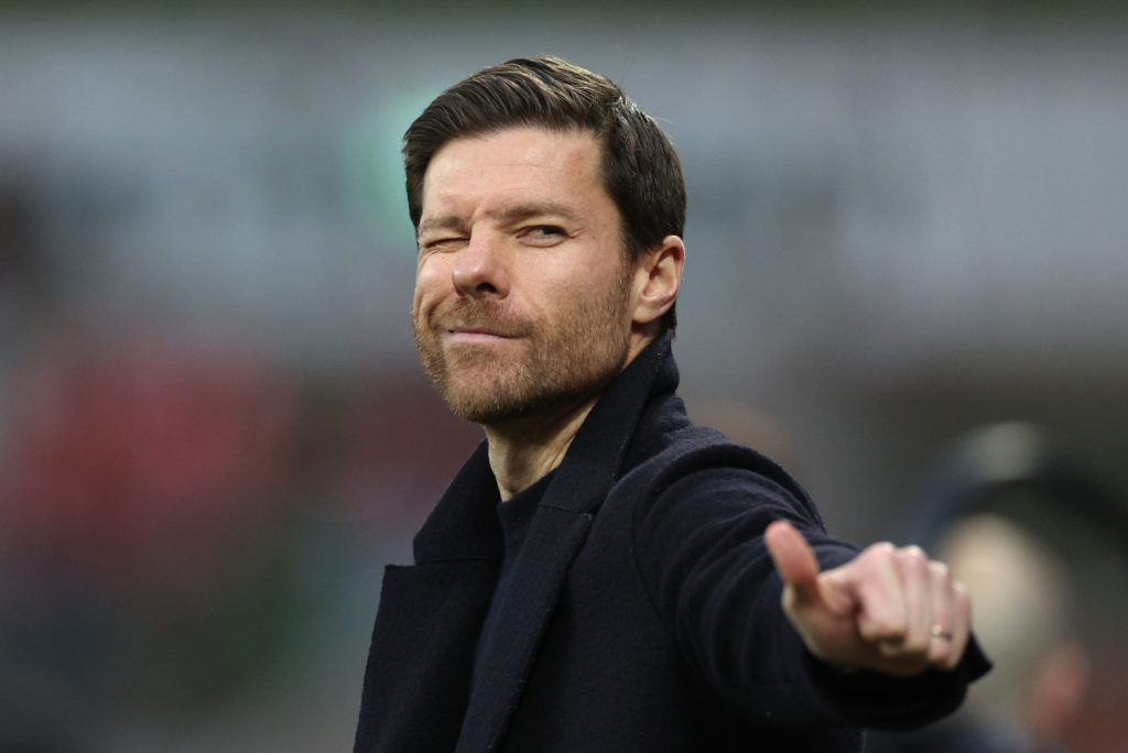 Bayer Leverkusen manager Xabi Alonso winking during a Bundesliga game against Bayern Munich