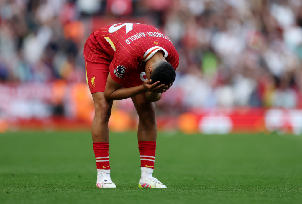 Trent Alexander-Arnold holds his head in his hands during Liverpool's 2-2 draw with Arsenal at Anfield.