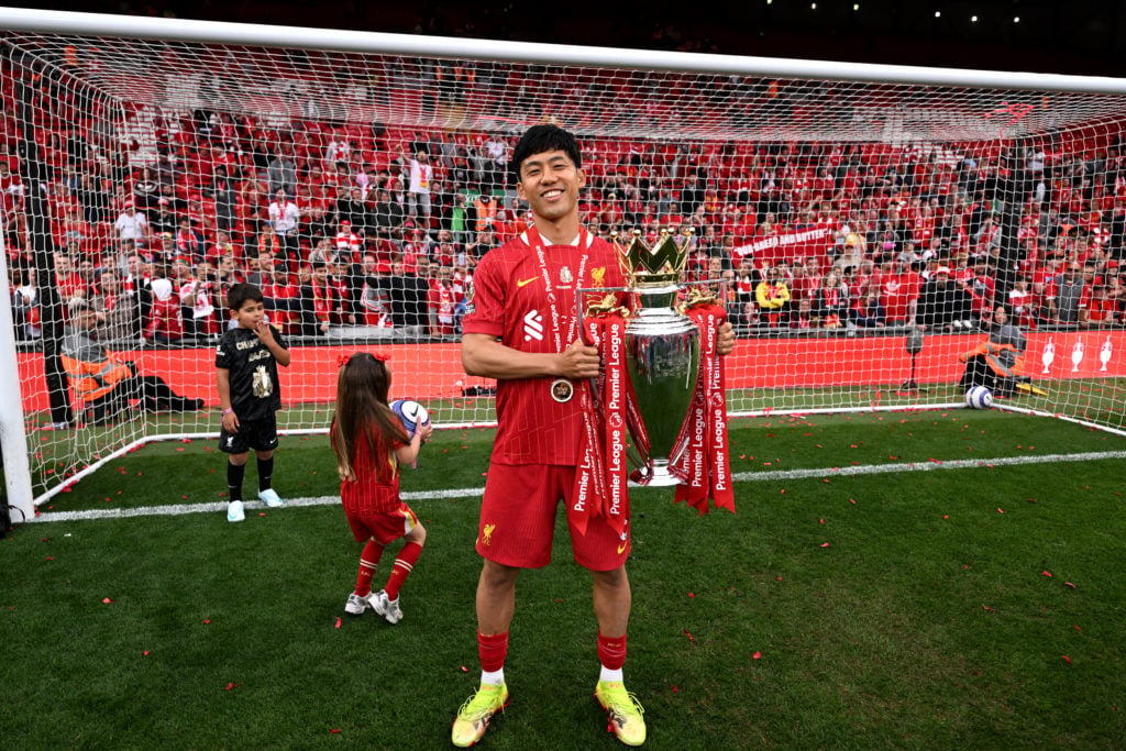Wataru Endo pictured holding the Premier League title.