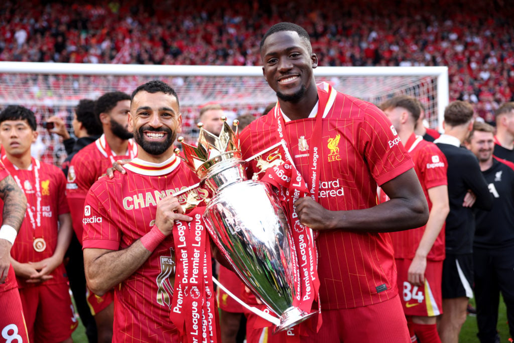 Mohamed Salah and Ibrahima Konate of Liverpool pose with the Premier League trophy at Anfield,