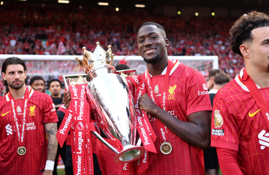 Ibrahima Konate of Liveprool poses with the Premier League trophy at Anfield