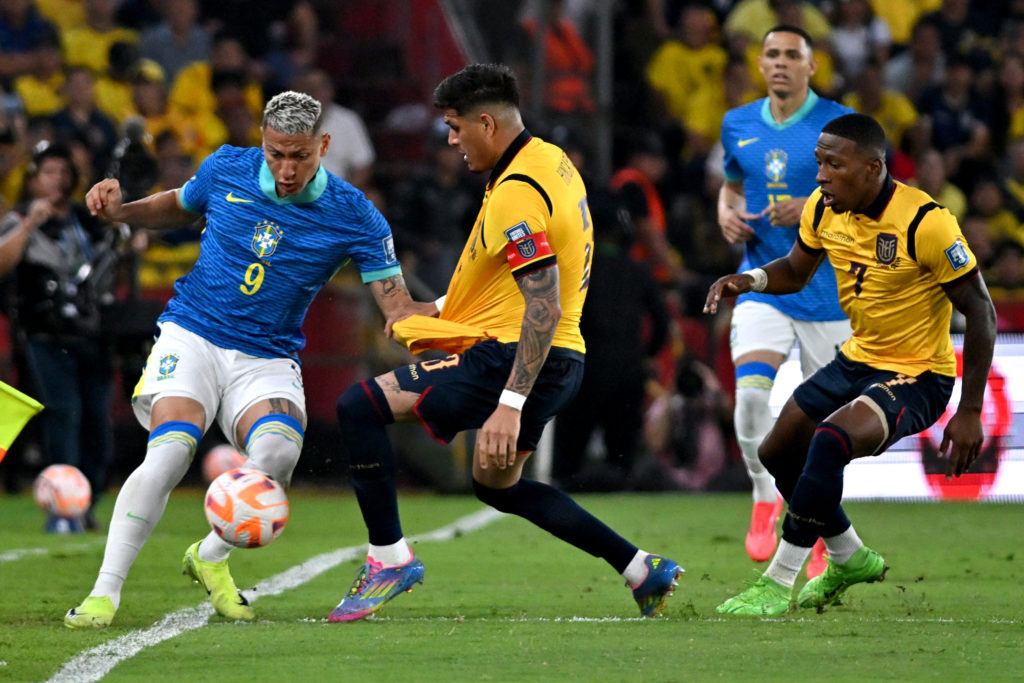 Brazil forward Richarlison engages in a tackle with Ecuador defender Piero Hincapie during a World Cup qualifier.