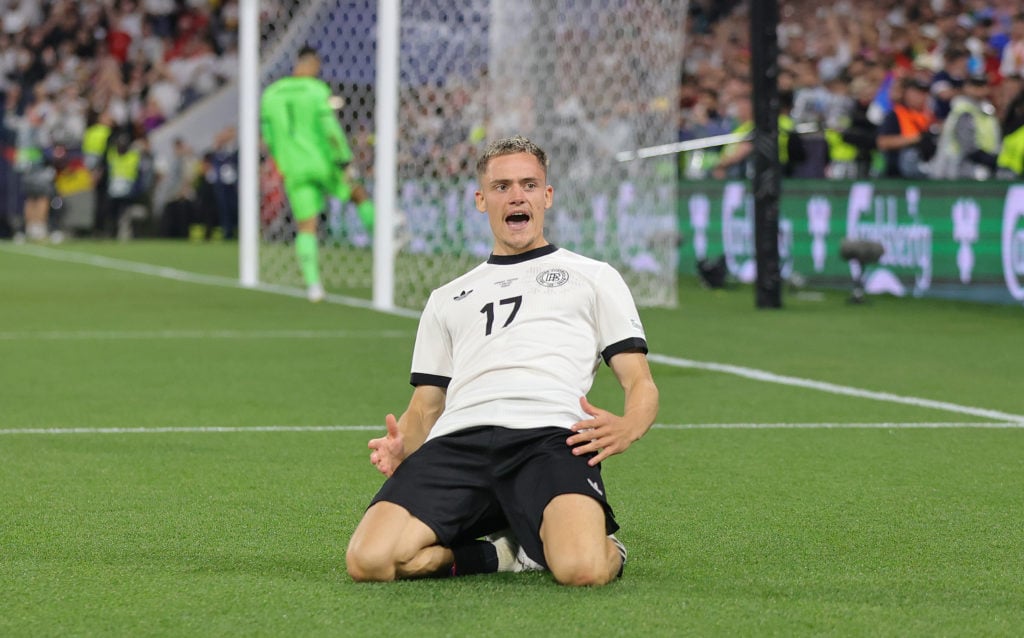 Florian Wirtz celebrates with a knee slide after scoring for Germany against Portugal in the UEFA Nations League semi-final.