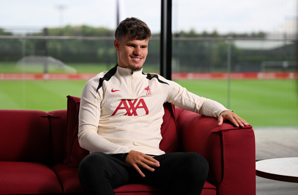 Milos Kerkez smiles as he sits down for his first interview as a Liverpool player at the AXA Training Centre.