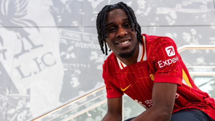 Jeremie Frimpong smiles as he poses following his unveiling as a new Liverpool player.