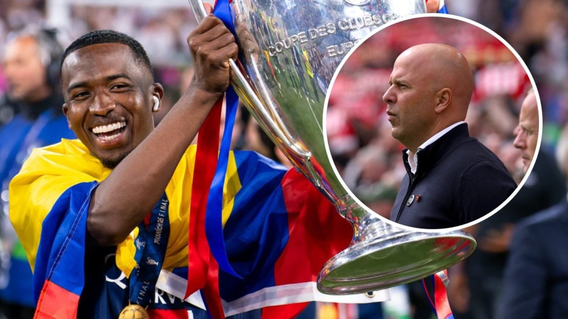 Willian Pacho of PSG lifts the Champions League trophy after beating Inter Milan at the Allianz Arena. Liverpool head coach Arne Slot looks on duri...