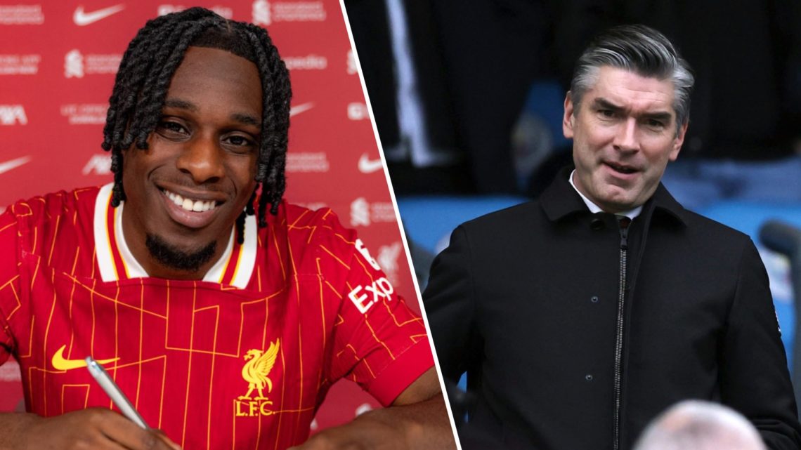 Jeremie Frimpong smiles as he signs in as a new Liverpool player. Liverpool sporting director Richard Hughes watches on during a Premier League mat...