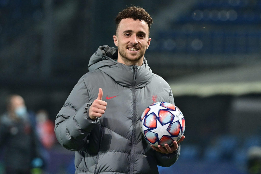 Diogo Jota of Liverpool holds the match ball after scoring a hat-trick against Atalanta in the UEFA Champions League.