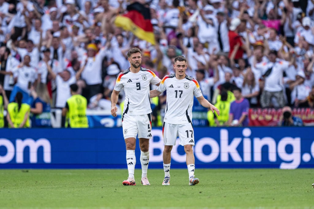 Florian Wirtz (R) celebrates after scoring his team's first goal with Niclas Fuellkrug (L) during the UEFA EURO 2024 quarter-final match between Spain and Germany at Stuttgart Arena