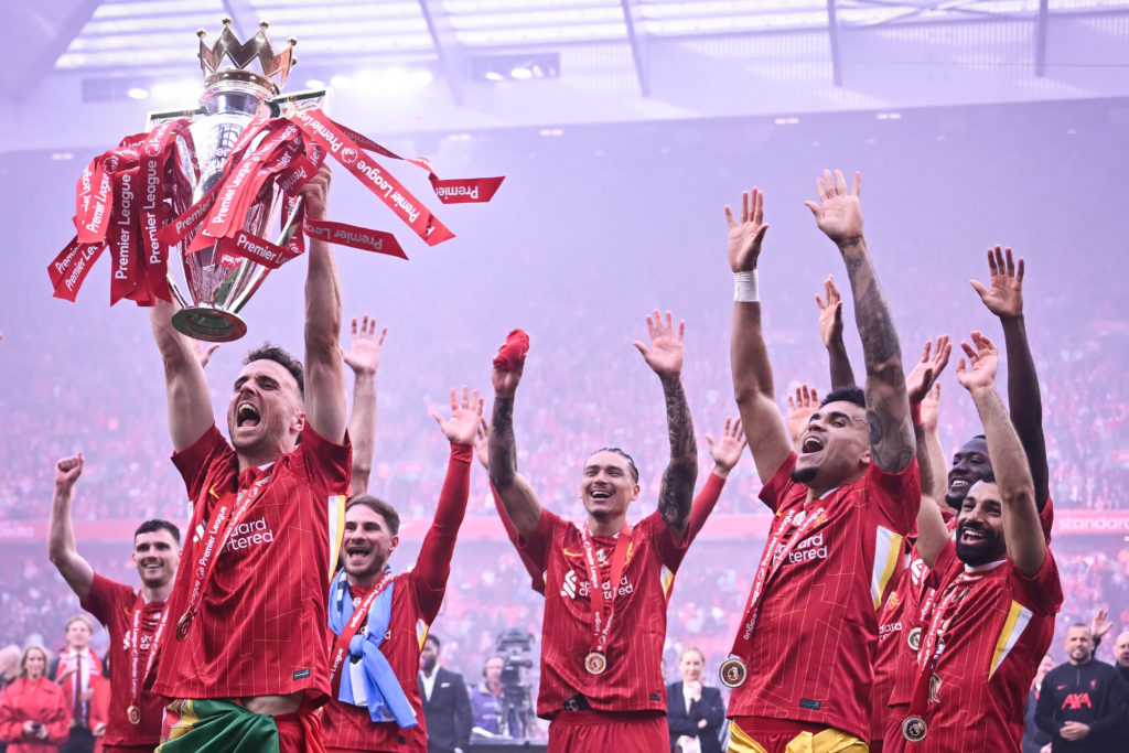 Liverpool's Diogo Jota lifts the Premier League trophy at Anfield after the final match of the 2024/25 season.