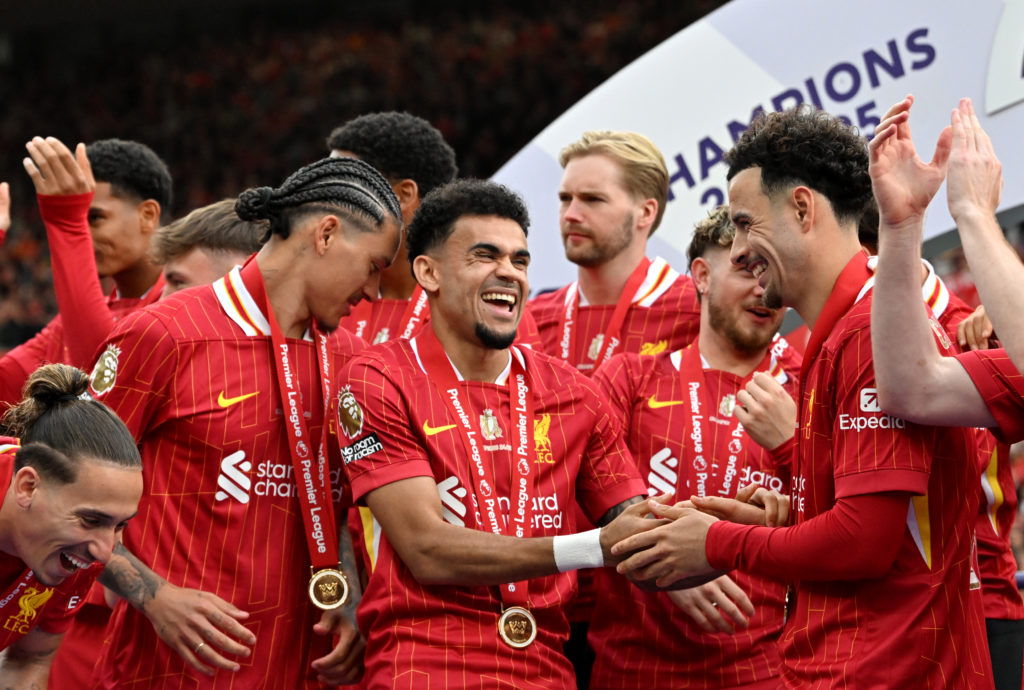 Luis Diaz celebrates with Curtis Jones and Darwin Nunez after lifting the Premier League trophy with Liverpool at Anfield.