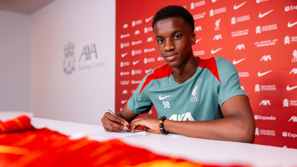Trey Nyoni smiles at the camera as he signs a new Liverpool contract at the AXA Training Centre.
