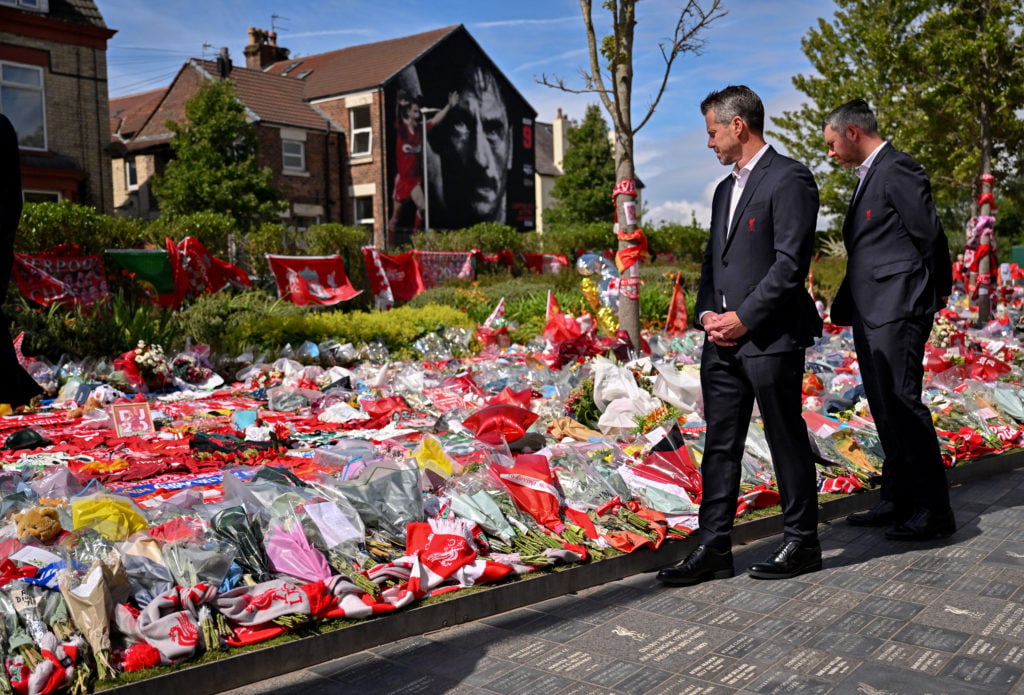 Liverpool CEO Billy Hogan stands at the memorial for Diogo Jota at Anfield.