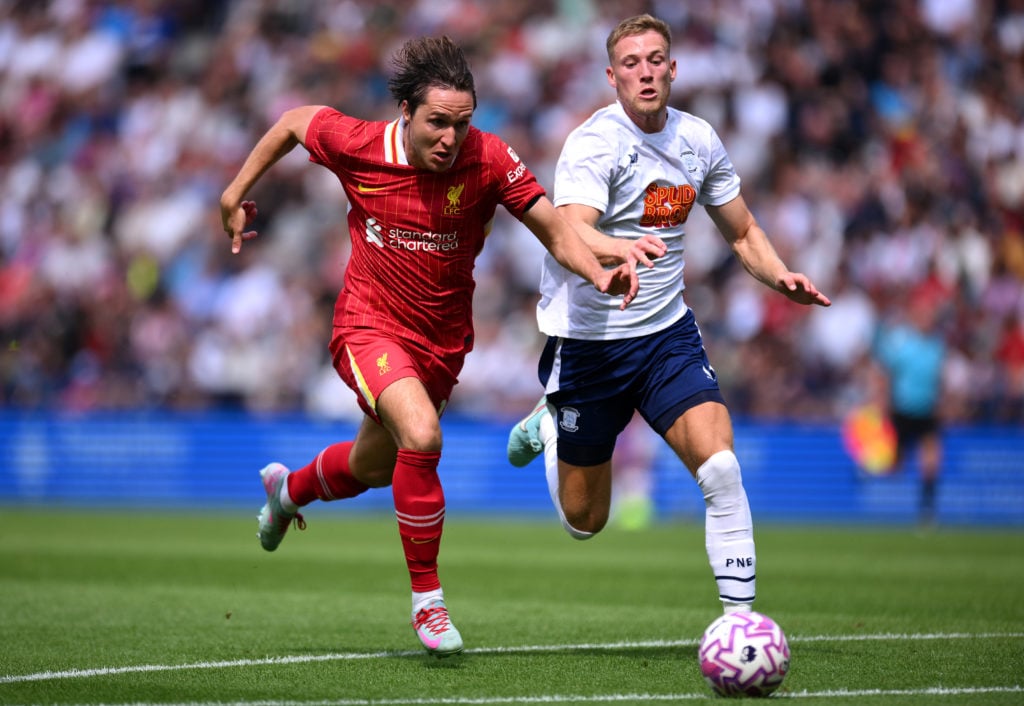 Federico Chiesa of Liverpool runs with the ball whilst under pressure from Lewis Gibson of Preston North End during the pre-season friendly match between Preston North End and Liverpool at Deepdale