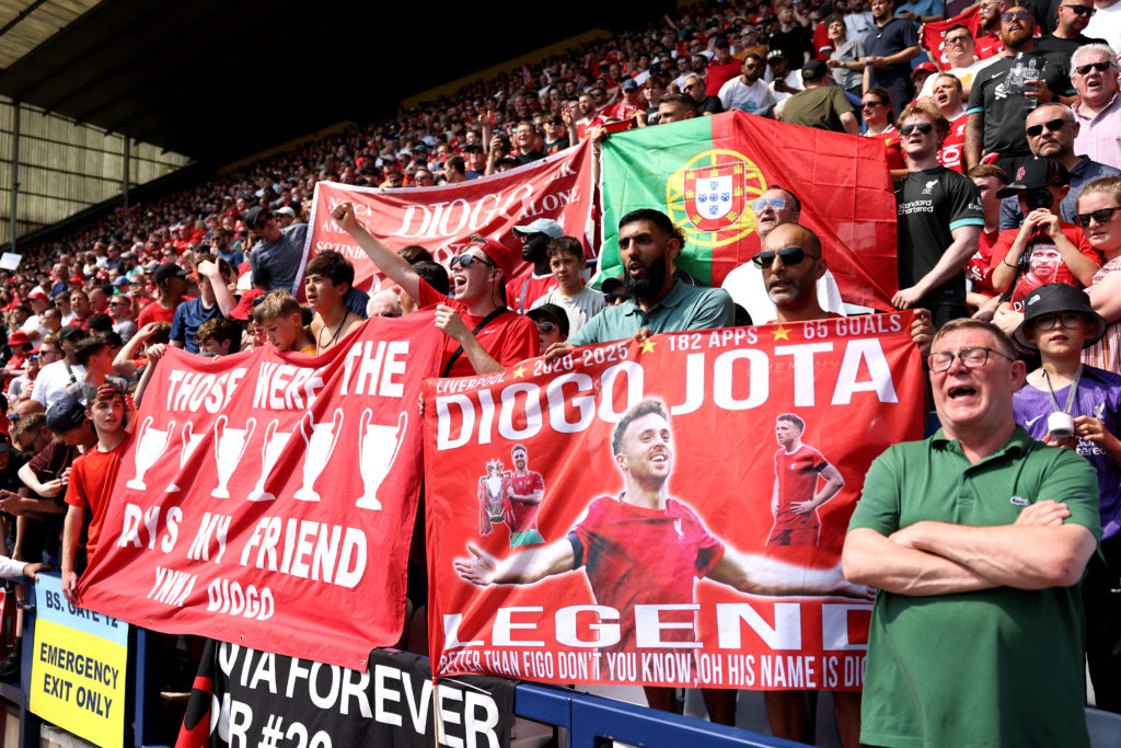 Liverpool fans display flags commemorating Diogo Jota who passed away with his brother Andre Silva