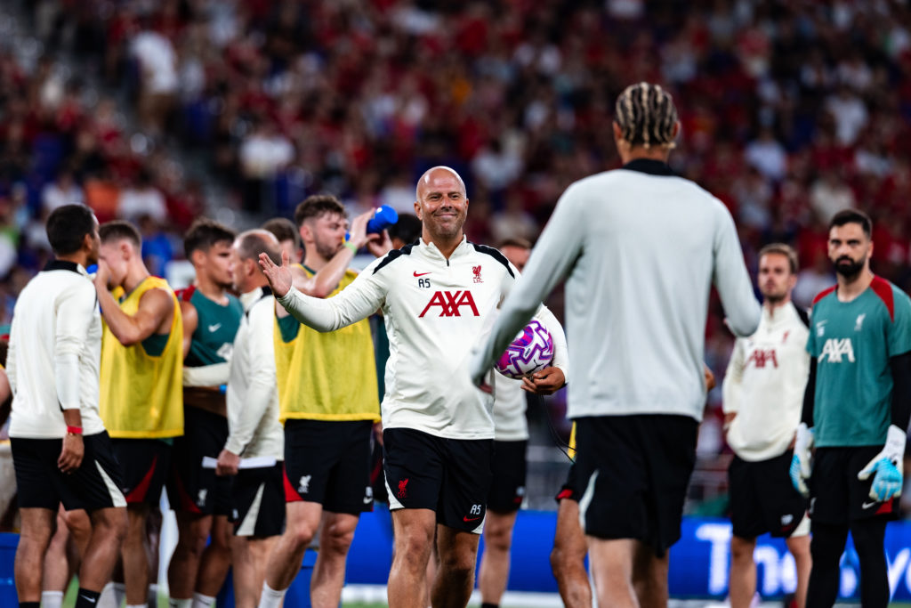 Arne Slot greets Hugo Ekitike as a new Liverpool signing during an open training session at the Kai Tak Stadium in Hong Kong.