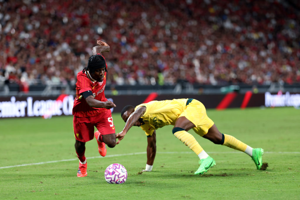 Jeremie Frimpong of Liverpool runs with the ball under pressure from Pervis Estupinan of AC Milan during the Pre-Season Friendly between Liverpool FC and AC Milan at Kai Tak Sports Park