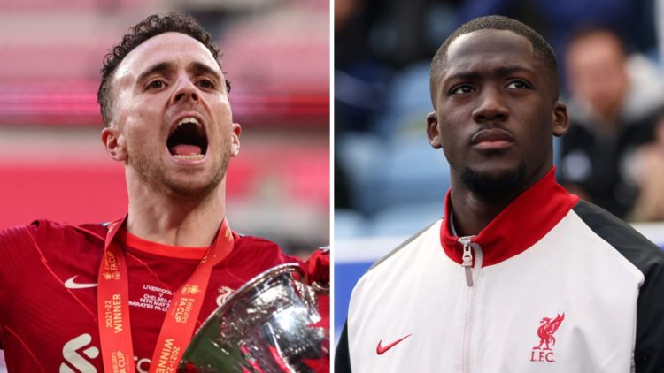 Diogo Jota clenches his fist in celebration as he holds the FA Cup in front of Liverpool supporters at Wembley Stadium. Ibrahima Konate walks out a...