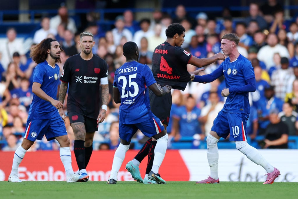 Cole Palmer scuffles with Jarell Quansah during a friendly between Chelsea and Bayer Leverkusen at Stamford Bridge.