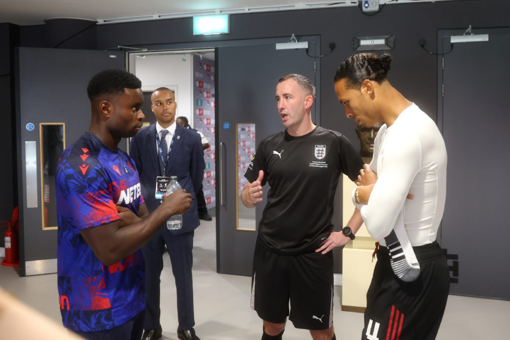 Marc Guehi and Virgil van Dijk talks to referee Chris Kavanagh ahead of the 2025 Community Shield between Liverpool and Crystal Palace at Wembley Stadium