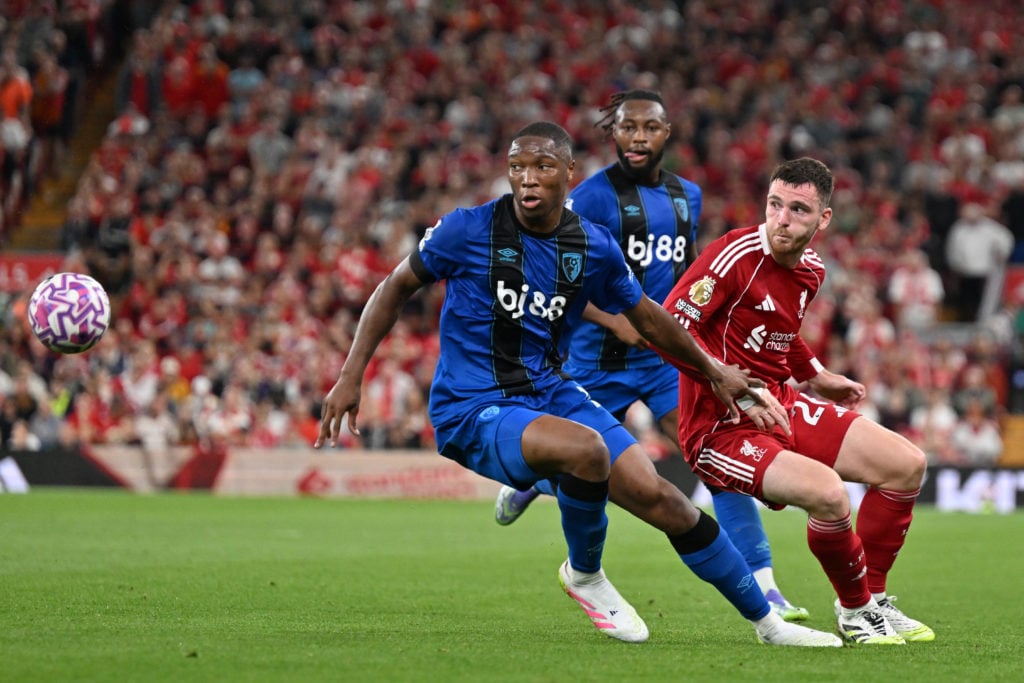 Bafode Diakite of AFC Bournemouth and Andrew Robertson of Liverpool battle for possession during the Premier League match between Liverpool and Bournemouth at Anfield