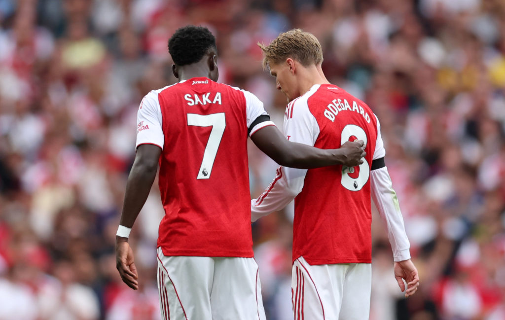 Bukayo Saka helps Martin Odegaard off the field during Arsenal's Premier League match against Leeds United at the Emirates Stadium