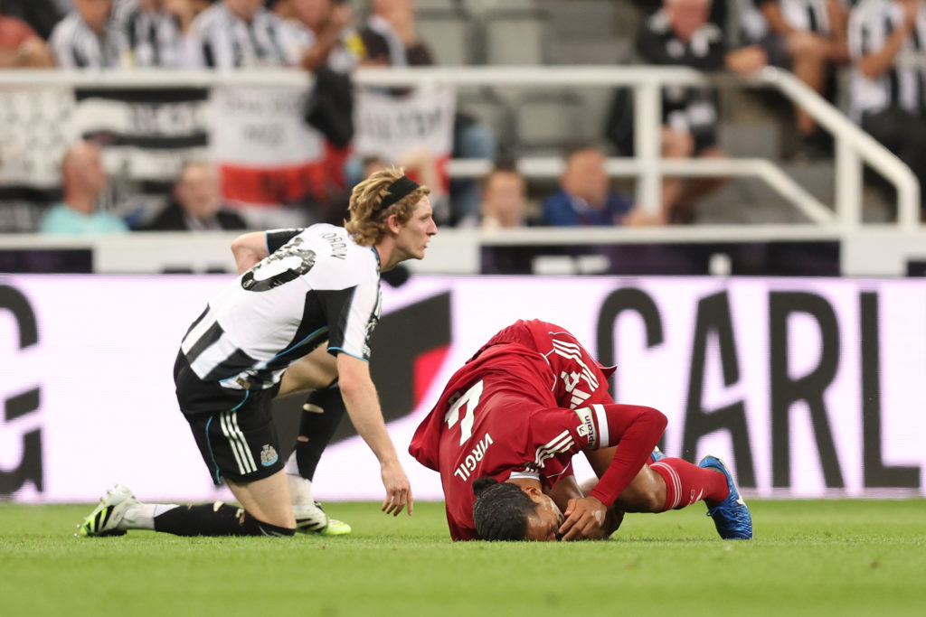 Virgil van Dijk of Liverpool reacts after being fouled by Anthony Gordon of Newcastle United, which results in a red card following a VAR review to upgrade to the initial yellow card during the Premier League match between Newcastle United and Liverpool at St James' Park.