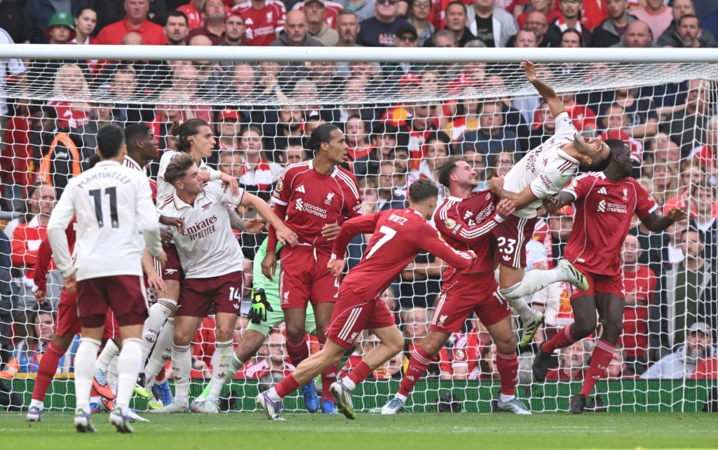 Liverpool and Arsenal players attack a corner during a Premier League at Anfield