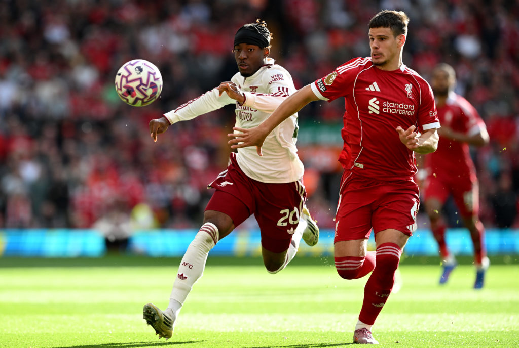 Noni Madueke of Arsenal is challenged by Milos Kerkez of Liverpool during the Premier League match between Liverpool and Arsenal at Anfield.