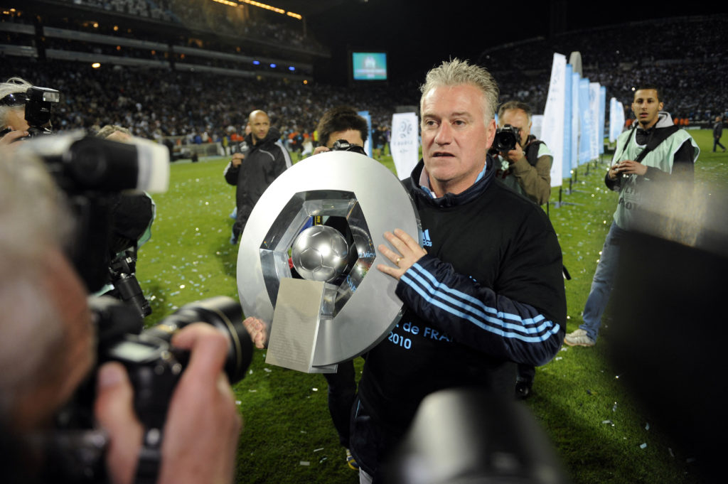 Marseille's coach Didier Deschamps poses with the French L1 trophy at the end of the French L1 football match Marseille vs. Grenoble, on May 15, 2010 at the Velodrome Stadium in Marseille