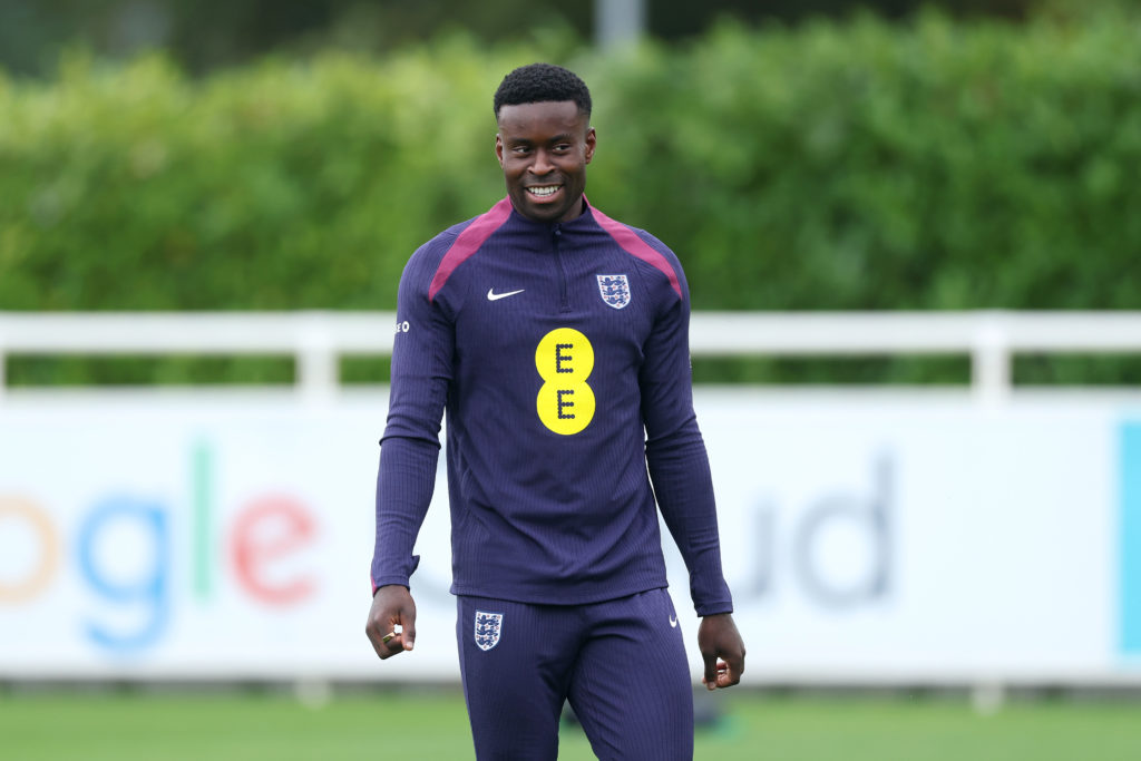Marc Guehi smiles while training for England during a session at St George's Park.